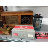 A pre war battery accumulator together with a vintage radio and batteries.