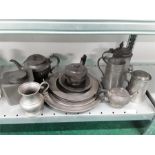 A collection of pewter to include tankards, plates etc.