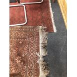 Two large carpets in red and brown, geometric pattern.