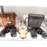 Two pairs of binoculars together with a small barometer.