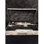 A B&H 400 trumpet in case.