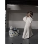 A Lladro Angel girl together with a Nao figure of two dogs in a basket.