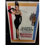 A framed poster depicting Audrey Hepburn Breakfast at Tiffany's.