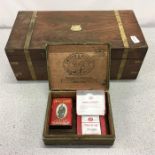 A writing box with a Benson & Hedges cigar box and a collectors pack of cigarettes