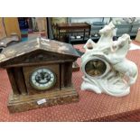 A marble mantle clock with another styled as horses and an onyx clock.