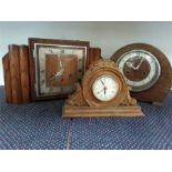 Three various wooden mantle clocks.