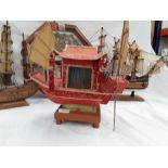 Two model ships, a picture depicting knots and a lamp depicting a Chinese style boat.