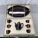 A lacquered tea set in case together with meat dishes and a pot.