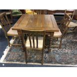 An oak draw leaf table x cross stretcher turned legs and four chairs.