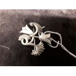 An Ivan Tarratt/George Bellamy silver brooch decorated with stylised flowers. Makers mark and