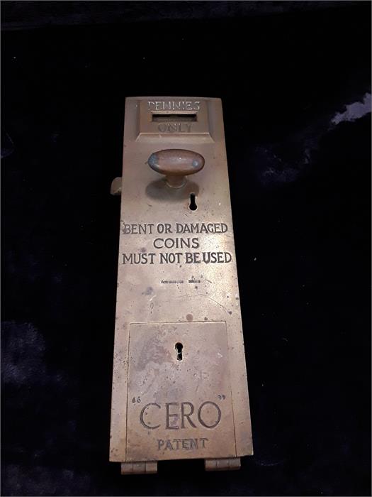 A brass toilet door lock penny slot handled.