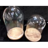 Two glass domes with base.