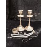 A pair of silver candlesticks, napkin ring holder etc.