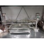 A quantity of silver plate items warmer, tea set, candlesticks etc.