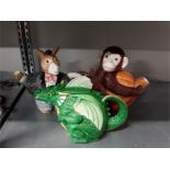 Three novelty china teapots in the form of a monkey, a donkey and a dragon.