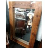 A large pine framed mirror.