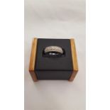 An 18 carat white gold diamond band ring, size M.