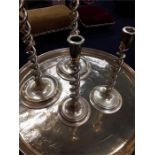 A large Indian brass tiffin tray with four twisted brass candlesticks.
