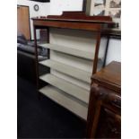 A four tier Edwardian bookcase with glass sides.