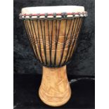 A medium sized carved African tribal Bongo drum.