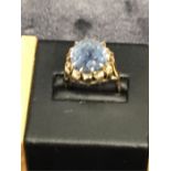 A 9ct gold ring set with large blue stone.