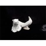 Nao-art deco style dove, damage to neck, impressed marks to the bottom, with a Lladro seated polar