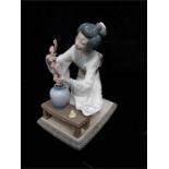 A study of a Lladro-oriental lady flower arranging with box.