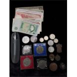 A cigar box containing mixed coins and notes.
