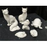 A collection of seven Poole Pottery white animals; two cats, one tortoise, one seal, one duck, one