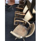 Two oak captains chairs and a pair of 1950s armchairs as found.