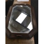 A 1920's oak framed wall mirror bevelled glass.