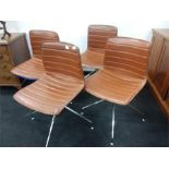 A set of four chrome and tan leather bucket chairs by Arup designs.