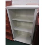 A white painted open bookcase.