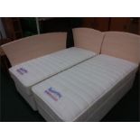 A pair of as new divan single beds with Slumberland memory foam mattresses and headboards.