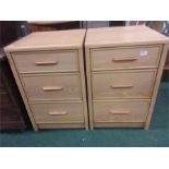 A pair of modern bedside three drawer cabinets.