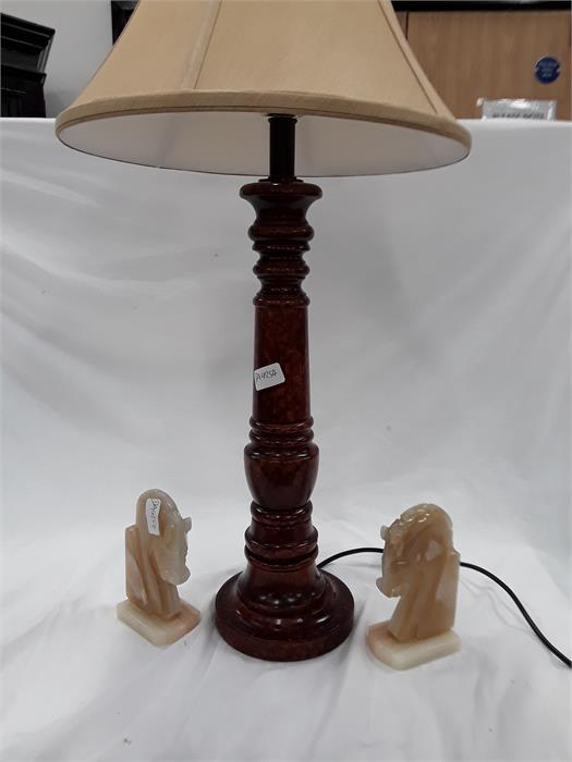 A table lamp and a pair of onyx bookends depicting horses.