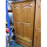 A pine double wardrobe with two drawers under.