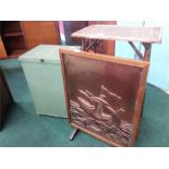 A copper firescreen together with a bamboo table and a laundry basket.