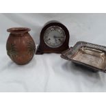 A wooden mantle clock together with a silver plate dish and a copper vase.