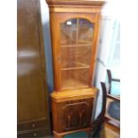 A yew wood corner display cabinet.