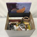 A box containing various arts and craft items, including paint, buttons, some pictures etc.