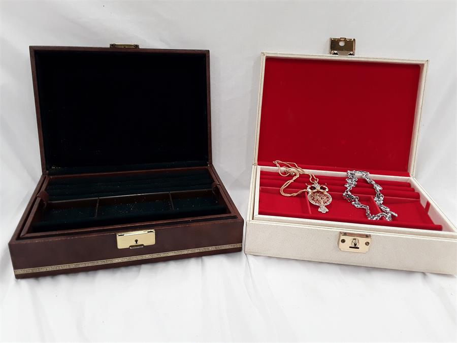 Two jewellery boxes and two costume jewellery necklaces.