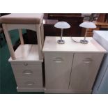 A modern double cabinet with bedside cabinet, stool and two lamps.