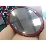 A mahogany framed oval hall mirror.