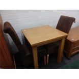 A light oak bistro table with two chairs.