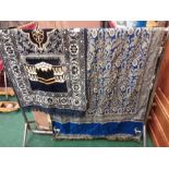 A large paisley rug with a prayer rug.
