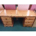 A pine twin pier dressing table of seven drawers.
