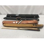 Four snooker cues and cases.