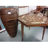 A small hexagonal inlaid table together with a wooden vase.