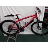A Specialized mountain bike. 27 speed with front suspension, hydraulic disc brakes and mudguards. In